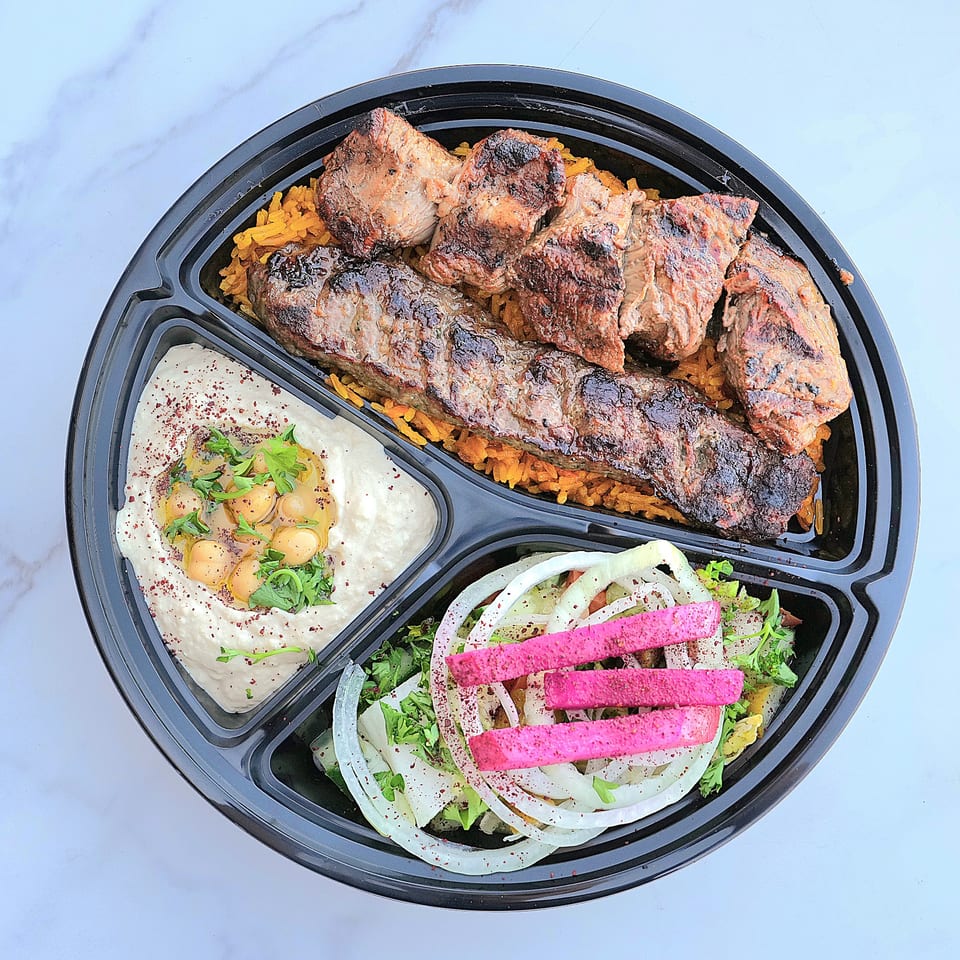 A Don Kabob platter with grilled meats, rice, hummus, and a salad with pickled turnips.